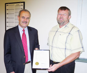 Boone County Presiding Commissioner Ken Pearson presents the proclamation for "Probation, Parole & Community Supervision Week" to unit supervisor David Meyer at the Probation and Parole office in Columbia July 20, 2009. 