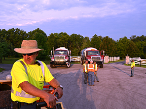 Roland Wren waits on the County's chip spreader as the work crew coordinates the morning's work