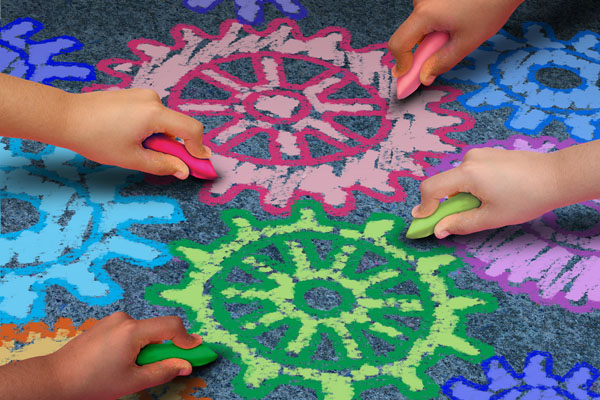 children's hands drawing gears with colorful chalk