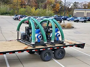 two large flood pumps on a flatbed trailer, ready to move