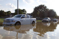 a flooded street with car tires nearly under water