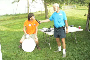 community volunteers help install rain barrels