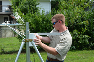 stormwater staff member tipping a rainwater bucket