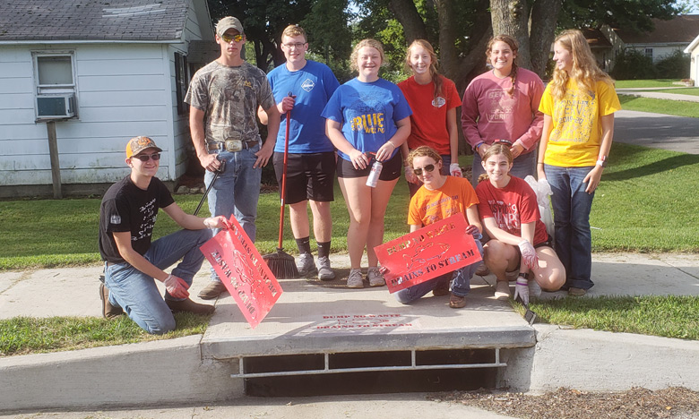 group of people marking a storm drain