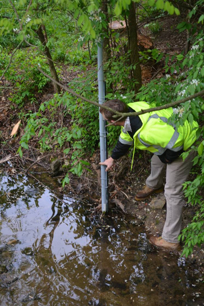 Ed Bulliner measures water level during peak flow event